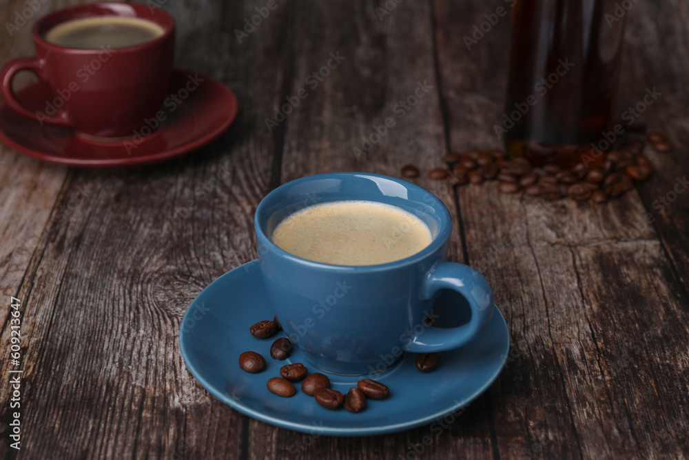 Fototapeta premium Delicious coffee and beans on wooden table