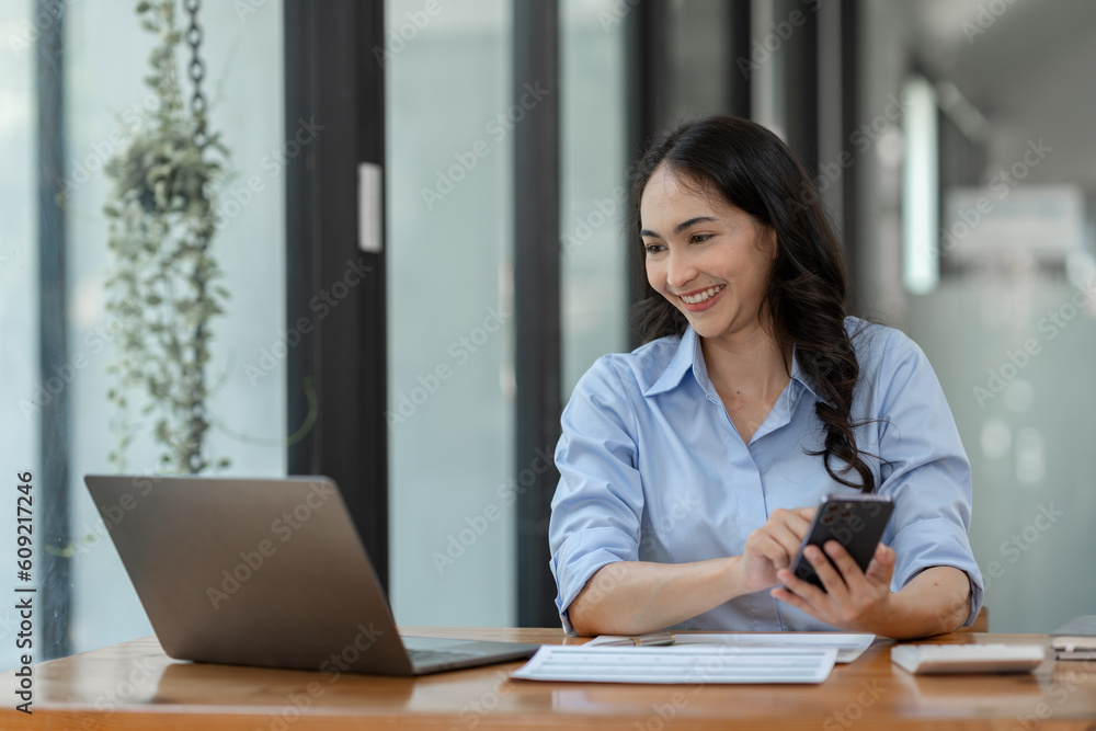 Confident businesswoman working using mobile phone to search for information Talk through an application about financial investments in real estate business projects. management system concept. Confident businesswoman working using mobile phone to search for information Talk through an application about financial investments in real estate business projects. management system concept.