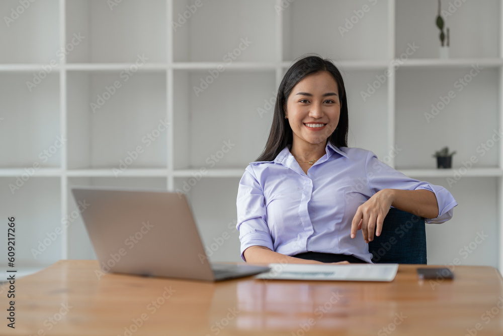 Businesswoman working using laptop to search for information Take note of the details. about financial investments Real estate business Document work to analyze the plan management system concept