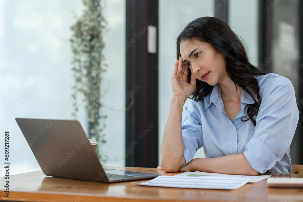 Asian businesswoman having stress, headache, office syndrome As a result of hard work on financial investment documents in Real estate business Document work for analysis management system concept. Asian businesswoman having stress, headache, office syndrome As a result of hard work on financial investment documents in Real estate business Document work for analysis management system concept.
