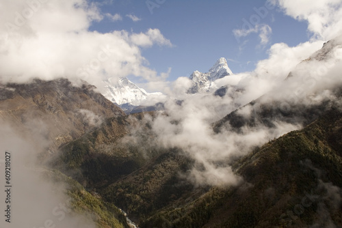 The trail from Namche Bazar to Phunki Tenga, Nepal. You can see Ama Dablam to the right and in the middle Nuptse, Lhotse, and Everest emerge from the clouds. photo