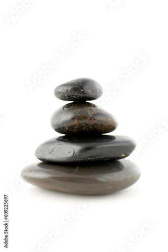 Stack of balanced stones with shadow on white background