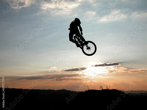 Mountain bike jump at the sunset