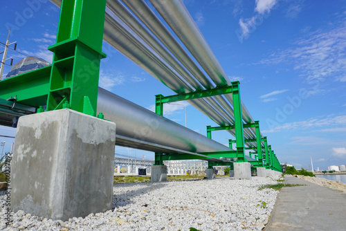 Photo Pipeline on green color pipe rack in oil and gas plant.