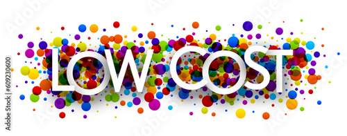 Banner with low cost sign over colorful round confetti background.