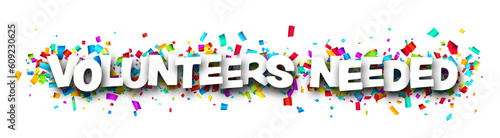 Volunteers needed sign over colorful cut out ribbon confetti background.