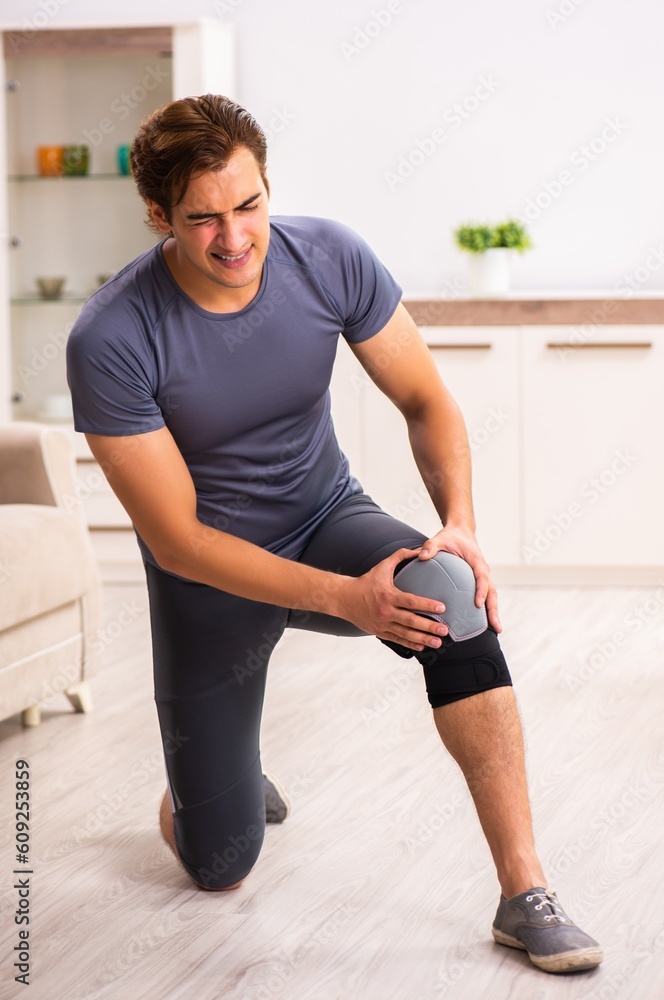 Young man with injured knee recovering at home Young man with injured knee recovering at home