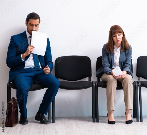 Fototapeta Naklejka Na Ścianę i Meble -  Young businessman and businesswoman waiting for an interview at