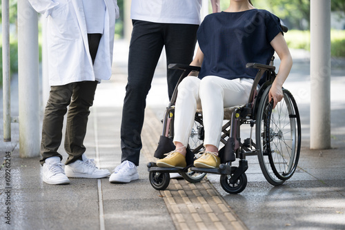Image of a person in a wheelchair and a doctor and medical care collaboration no-face