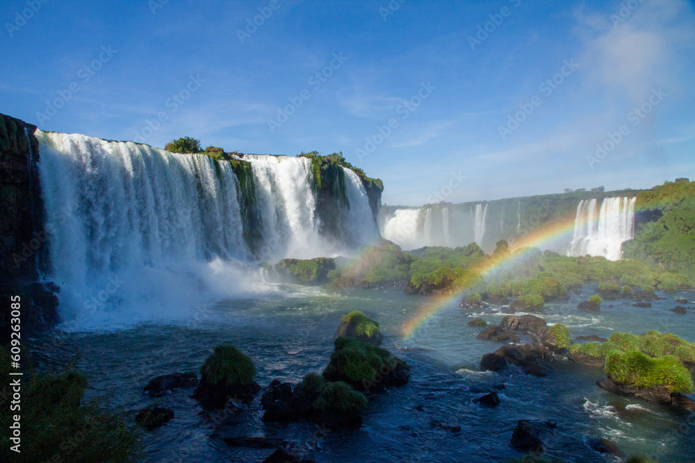 Iguazu Falls on the border between Argentina and Brazil with beautiful rainbows and lots of vegetation and lots of water falling down them