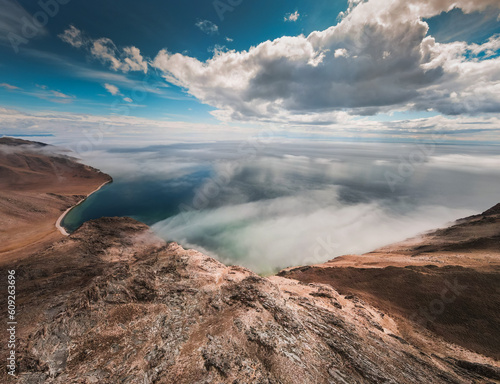 Beautiful shore of Baikal lake, cloud over the water. photo