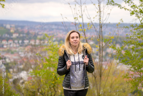 Woman in her forties standing on a mountain photo