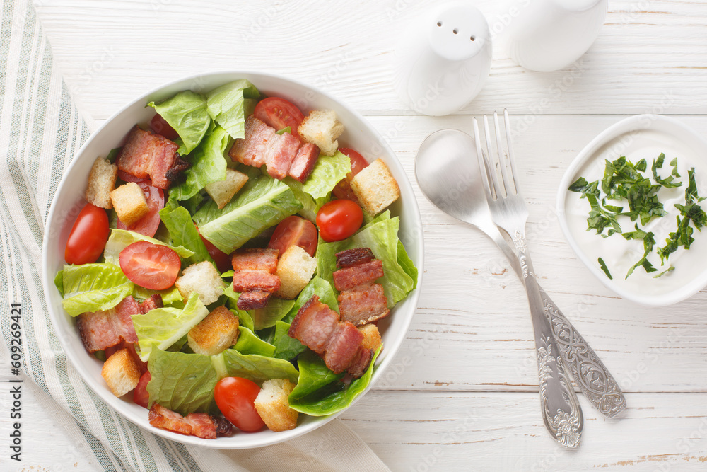 Healthy Organic BLT Bacon Salad with Lettuce and Tomato closeup on the plate on the table. Horizontal top view from above Healthy Organic BLT Bacon Salad with Lettuce and Tomato closeup on the plate on the table. Horizontal top view from above