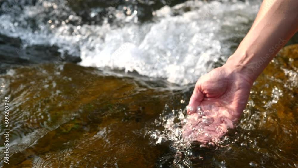 Hands touching water in nature and life concept Hands touching water in nature and life concept