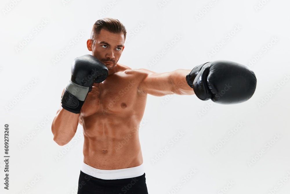 Man athletic bodybuilder poses in boxing gloves with nude torso abs in full-length background, boxing and martial arts. Advertising, sports, active lifestyle, competition, challenge concept. 