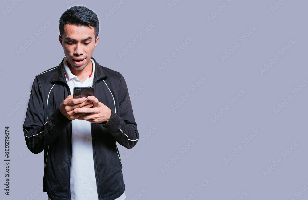 Smiling handsome boy texting with his cell phone isolated, young latin man happy with his cell phone isolated, happy teenager texting with his cell phone Smiling handsome boy texting with his cell phone isolated, young latin man happy with his cell phone isolated, happy teenager texting with his cell phone