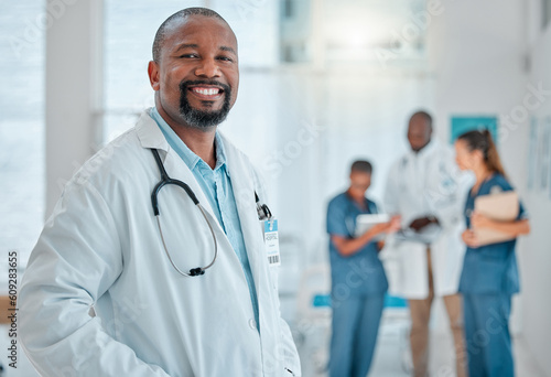 Happy, doctor and portrait of black man in hospital for medical help, insurance and trust. Healthcare, clinic team and face of professional male health worker smile for service, consulting and care