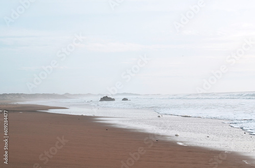 a cloudy day at a calm and serene deserted beach with minimal mood