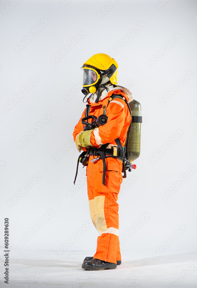 Side view of firefighter wearing yellow hard hat standing holding fire hose with both hands on white background. Side view of firefighter wearing yellow hard hat standing holding fire hose with both hands on white background.