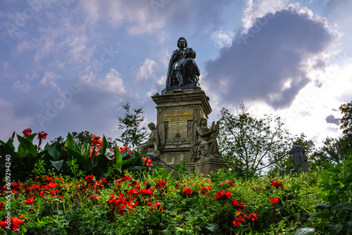 Vondel Monument Surrounded by Red Flowers - Vondelpark, Amsterdam photo