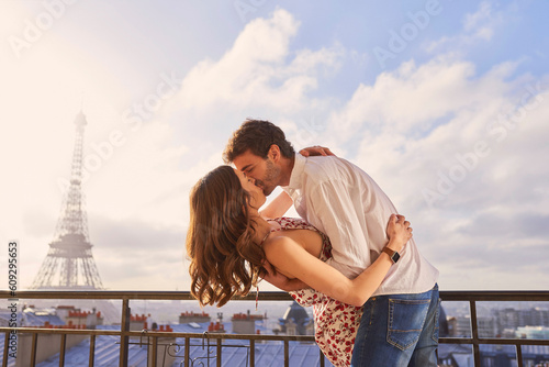 Photography Paris, love and couple together for a kiss, romantic time or balcony of apartment, hotel with Eiffel Tower in background