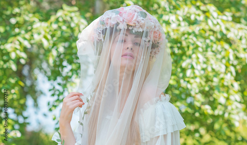 Tender Bride woman at nature, traditional real European lady with a long blond hair in white lace dress and wreath 