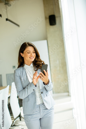 Young woman using mobile ph...