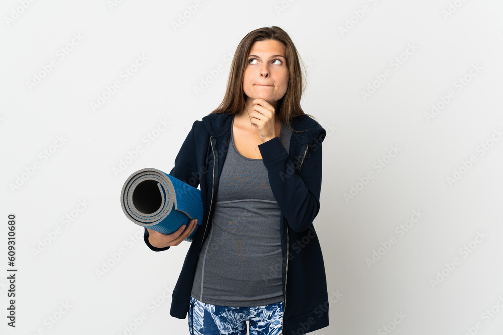 Obraz premium Slovak girl going to yoga classes isolated on white background having doubts and thinking