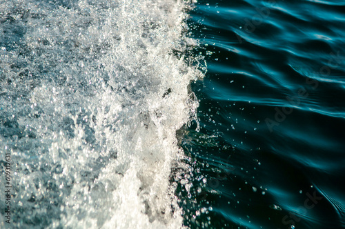 Wallpaper Mural Waves on the sandy beach. Water background, blue sea water. Beautiful texture of sun glare on the water and sea foam. Torontodigital.ca