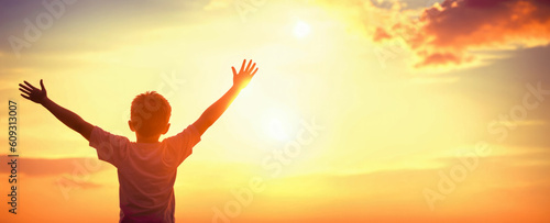 Boy raising hands over sunset sky, enjoying life and nature. Happy Kid in mountains looking on sun. Silhouette of child in sunlight rays. copy space. Generative AI