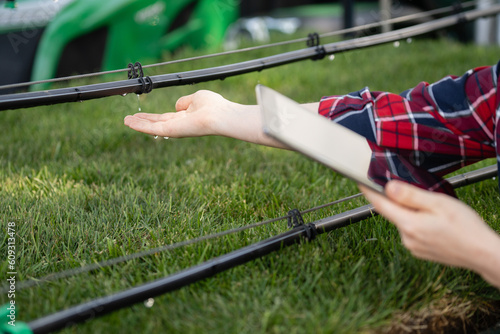 Farmer controls drip irrigation system with digital tablet