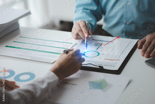 Fototapeta Naklejka Na Ścianę i Meble -  Businessman is reviewing monthly sales documents for analysis and marketing plans for more sales growth, they are the founders of young companies co-founding startups. Sales management concept.