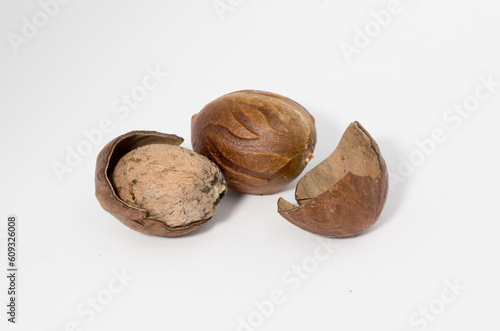 Nutmeg close-up on a white background. Indian spices close up. Medicinal herbs and spices.
