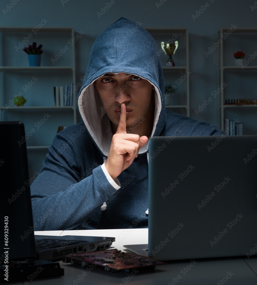 Hacker hacking computer at night Hacker hacking computer at night
