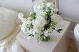 Beautiful bouquet on table. White flowers in the room.