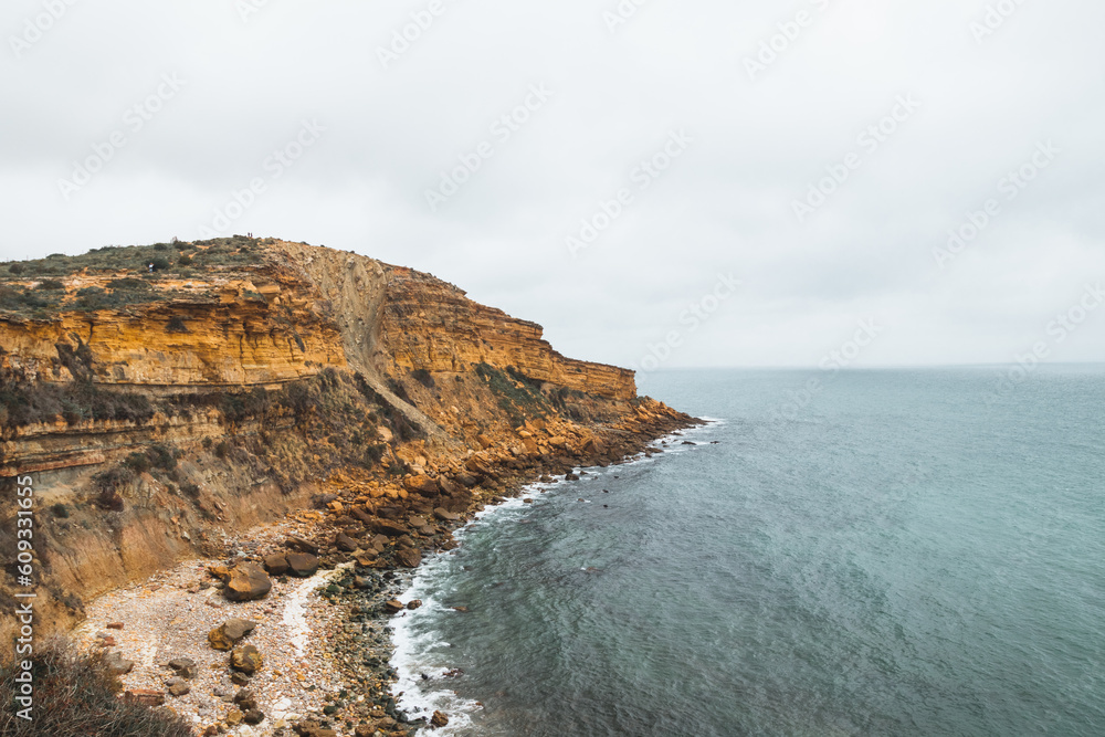 Mountainous coastline of Portugal's southern peninsula in the famous tourist region of the Algarve. The rocky cliffs around the town of Luz. Discovering the Fisherman trail, Rota Vicentina