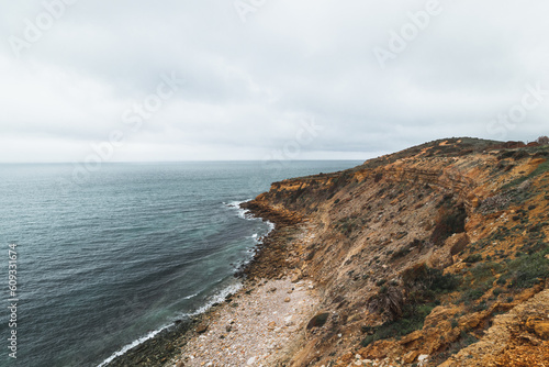 Mountainous coastline of Portugal's southern peninsula in the famous tourist region of the Algarve. The rocky cliffs around the town of Luz. Discovering the Fisherman trail, Rota Vicentina © Fauren