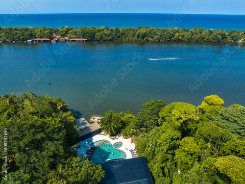 Luxury lodge in the middle of the jungle in Tortuguero, Costa Rica. Caribbean sea on the one side, village inside the jungle in the middle, and huge river on the otjer side. photo