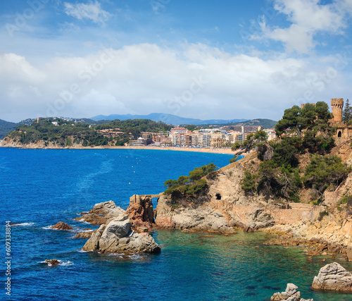 Summer sea rocky coast view with Castle of Sant Joan (Sa Caleta beach,  Lloret de Mar town, Catalonia, Spain). Peoples unrecognizable. photo