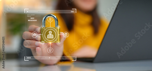 Cybersecurity concept. A person is holding onto a padlock containing a data privacy protection system from digital threats. Protect hardware, software and applications connect to work on the Internet.