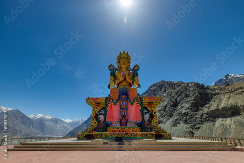 Big Sitting Buddha Statue at Diskit Monastery with Himalaya Range in the back - Nubra Valley, Ladakh, India

