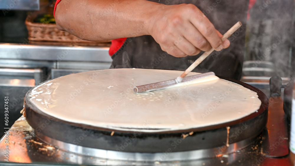 Fototapeta premium The chef prepares delicious pancakes.