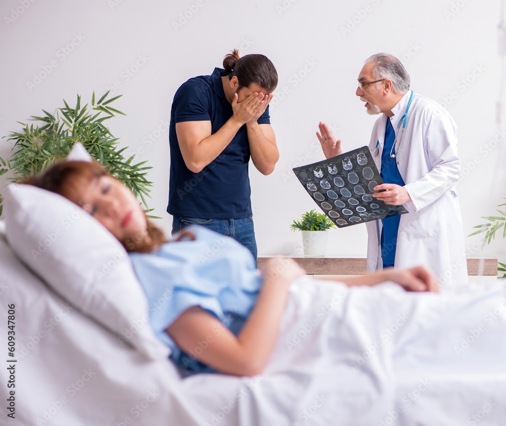 Young husband visiting sick wife in the clinic Young husband visiting sick wife in the clinic