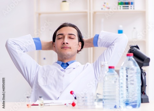 Young male chemist experimenting in lab