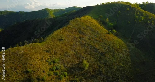 Aerial nature countryside landscape picturesque mountains hills forests meadows at sunset photo