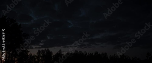 Timelapse of clouds over forest sunset anamorphic photo