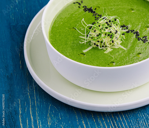 Plate of broccoli and green peas cream soup