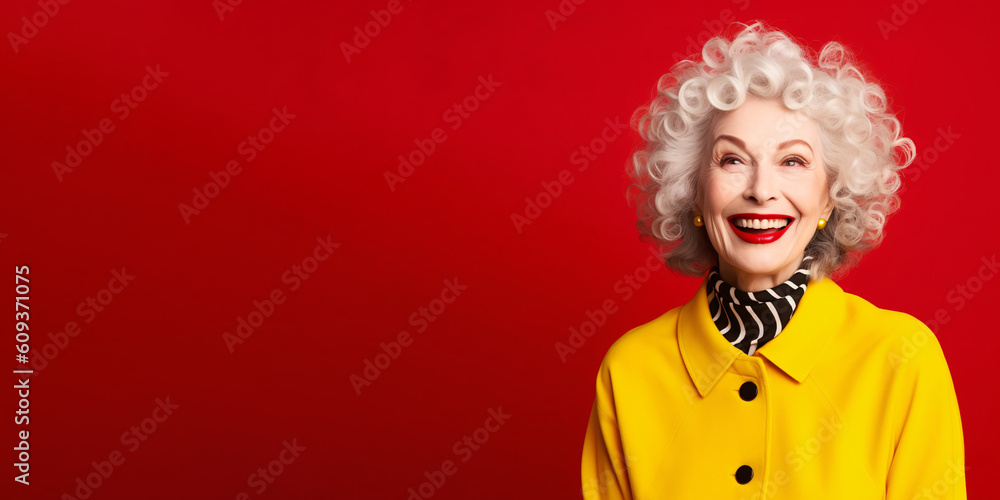 Energetic senior woman isolated on solid red background. Energetic senior woman isolated on solid red background.