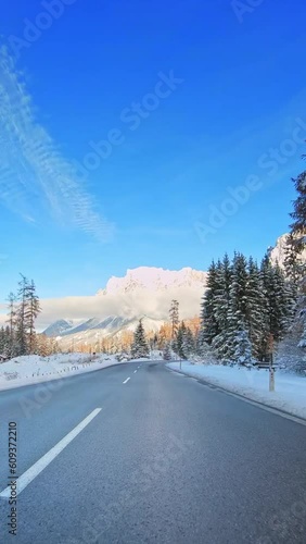 Nature, winter trip, POV drive on a mountain road, evergreen trees, snow-cover, vertical short video