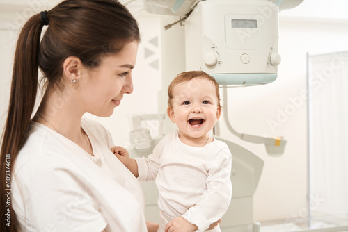 Young mom and joyful infant before radiography procedure